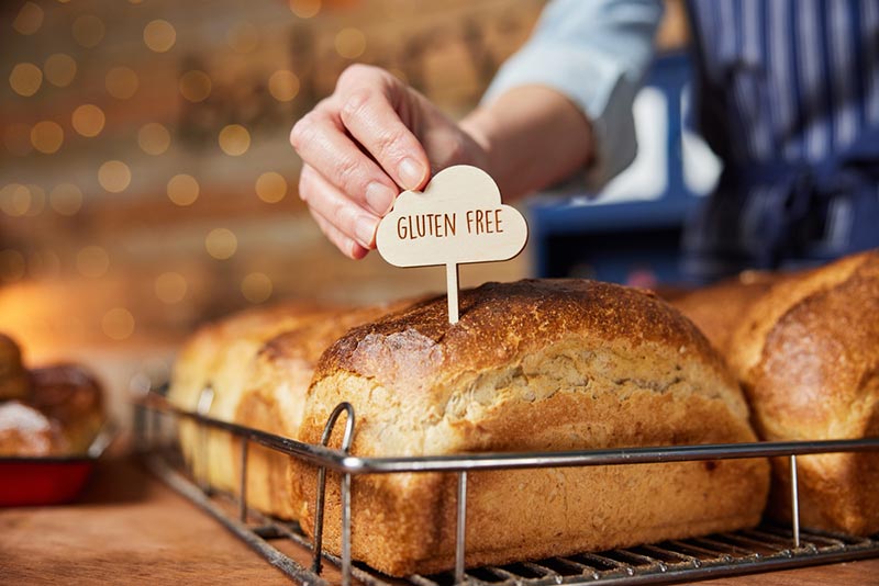 putting gluten free label into freshly baked loaves of bread