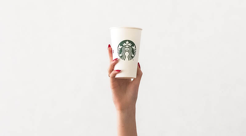 hand holding a cup of starbucks