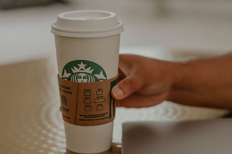 hand holding a hot starbucks drink