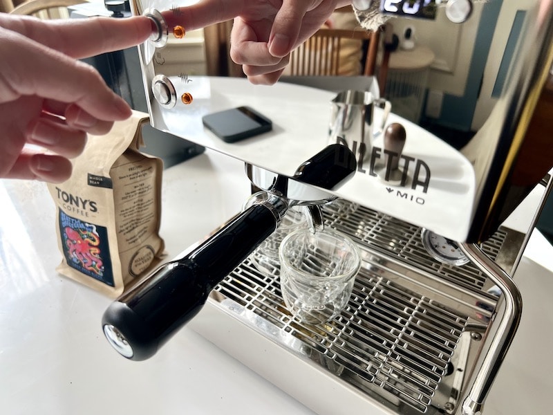 pushing brew button on Diletta Mio espresso machine