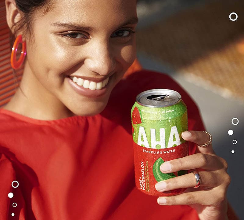woman holding a can of AHA Sparkling Water