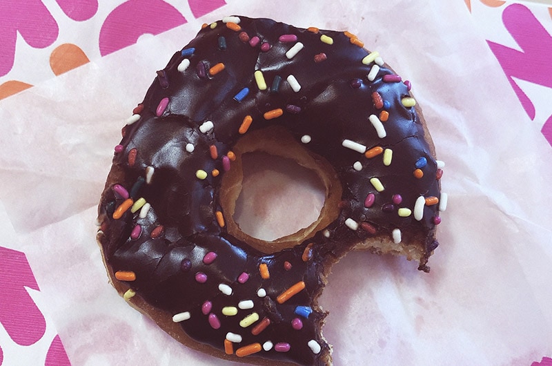 a bitten doughnut from dunkin donuts