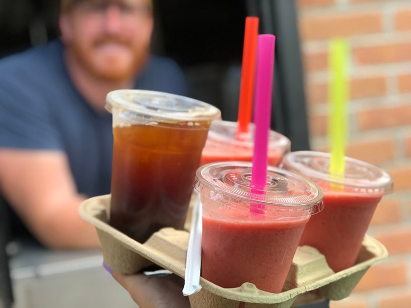 iced coffee and smoothies being picked up from a drive thru window