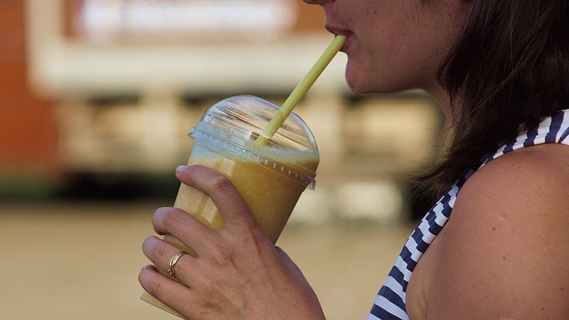woman drinking a smoothie