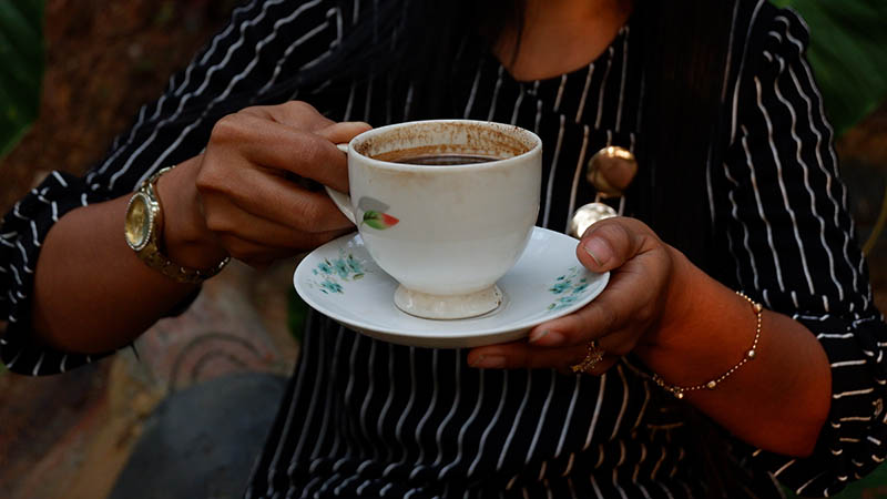 woman drinking a cup of black ivory coffee