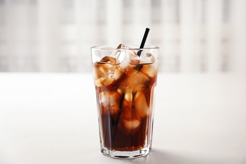 a glass of refreshing cola with ice
