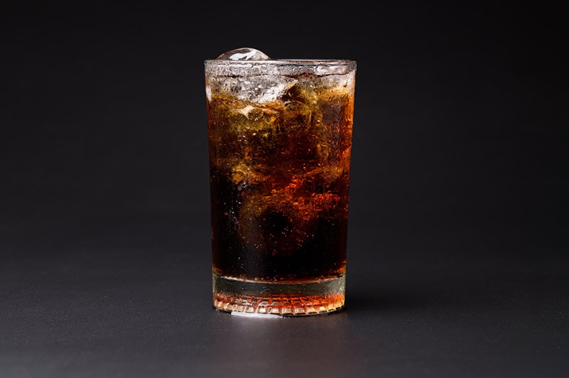 cola in a glass with ice cubes