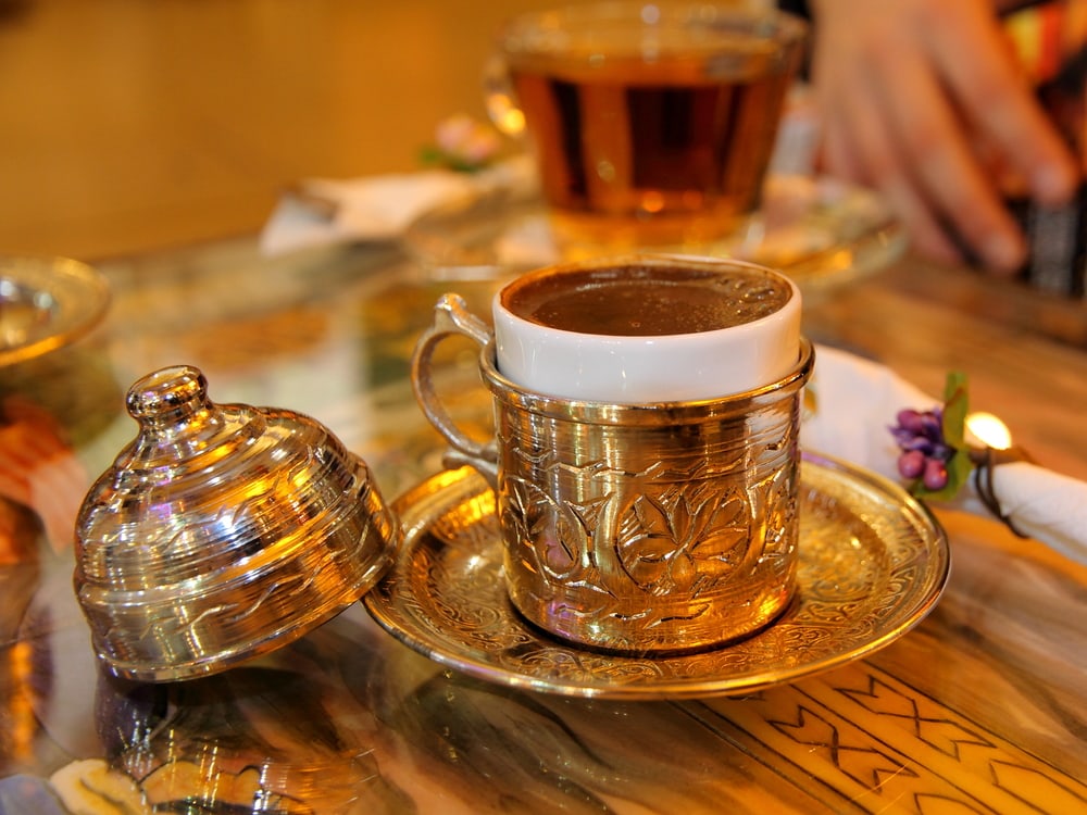 turkish coffee served in a traditional turkish metal dish cap