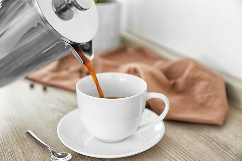 pouring a cup of percolated coffee