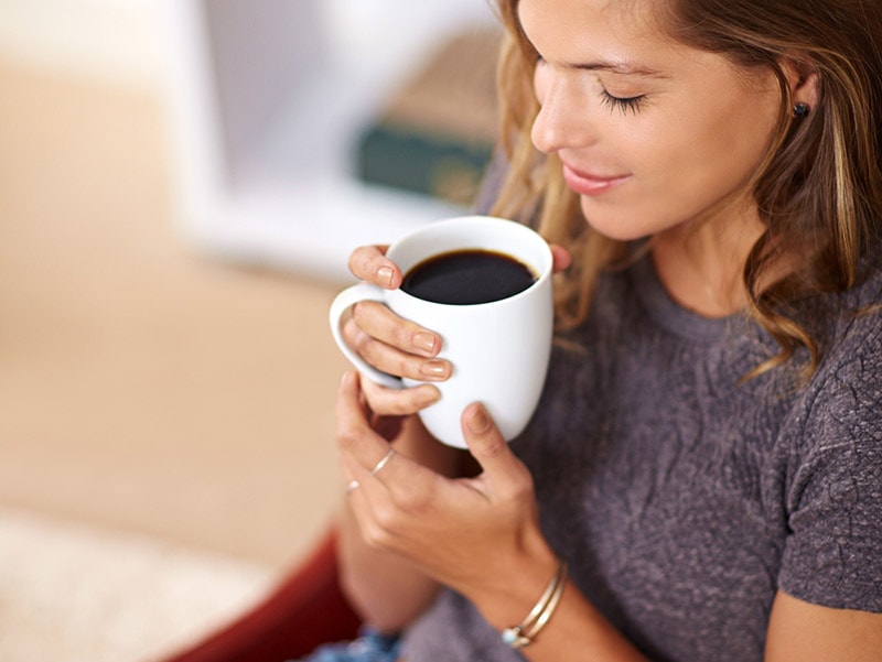 woman holding a cup of coffee