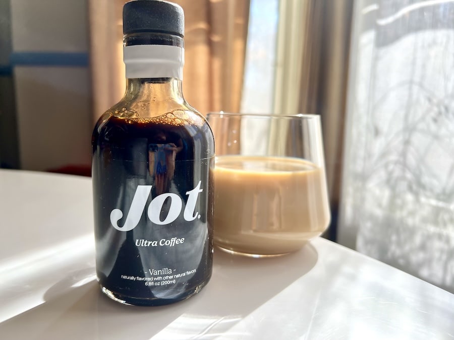 Jot Ultra Coffee Vanilla flavor in bottle with latte